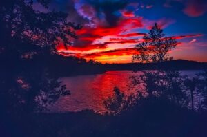 Sunset picutre on lake lanier with reds and blue colors in the sky